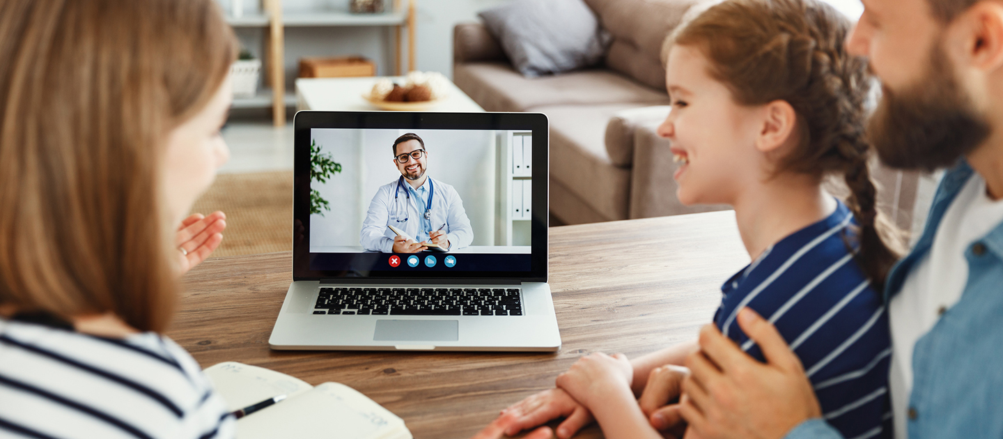 Parents and child on a video call with a Doctor.