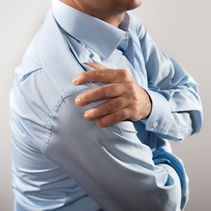 Man clutching shoulder in pain