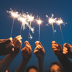 Group of people holding lit sparklers