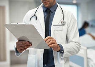 a doctor reviewing his clipboard - billing practices
