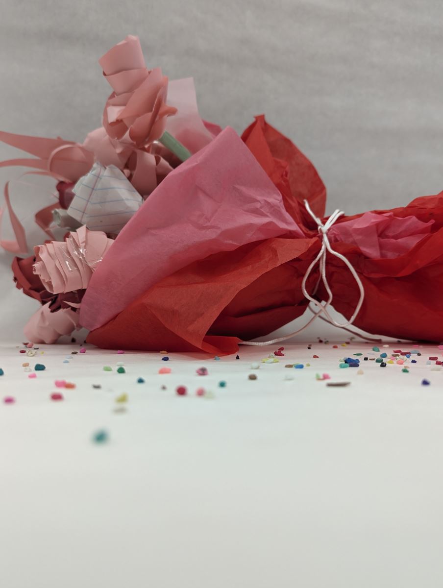 Scarlett S - Happy Forgotton Birthday: A bouquet of paper flowers on the ground