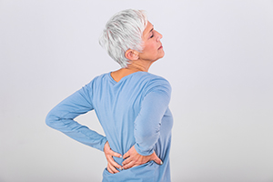 Older woman clutching back in pain