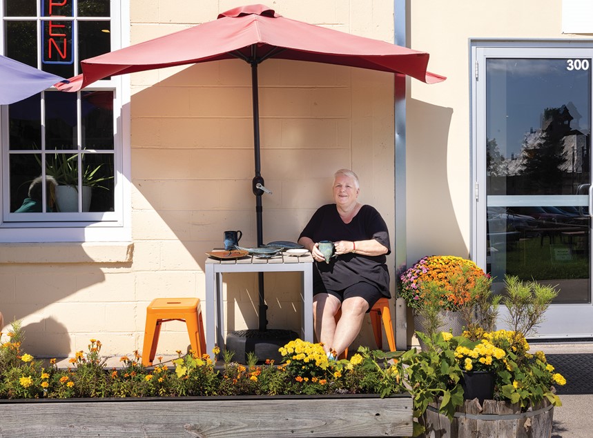 colleen tucker sits outside on a restaurant patio