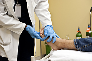 Clinician performing examination of patient's foot