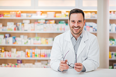 Smiling pharmacist at counter