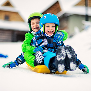 Two kids on a yellow sled