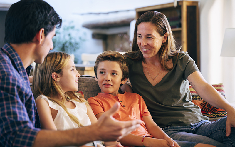 family talking while sitting around a table